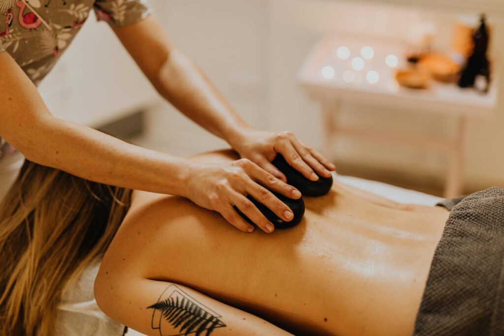 a tattooed woman having a massage